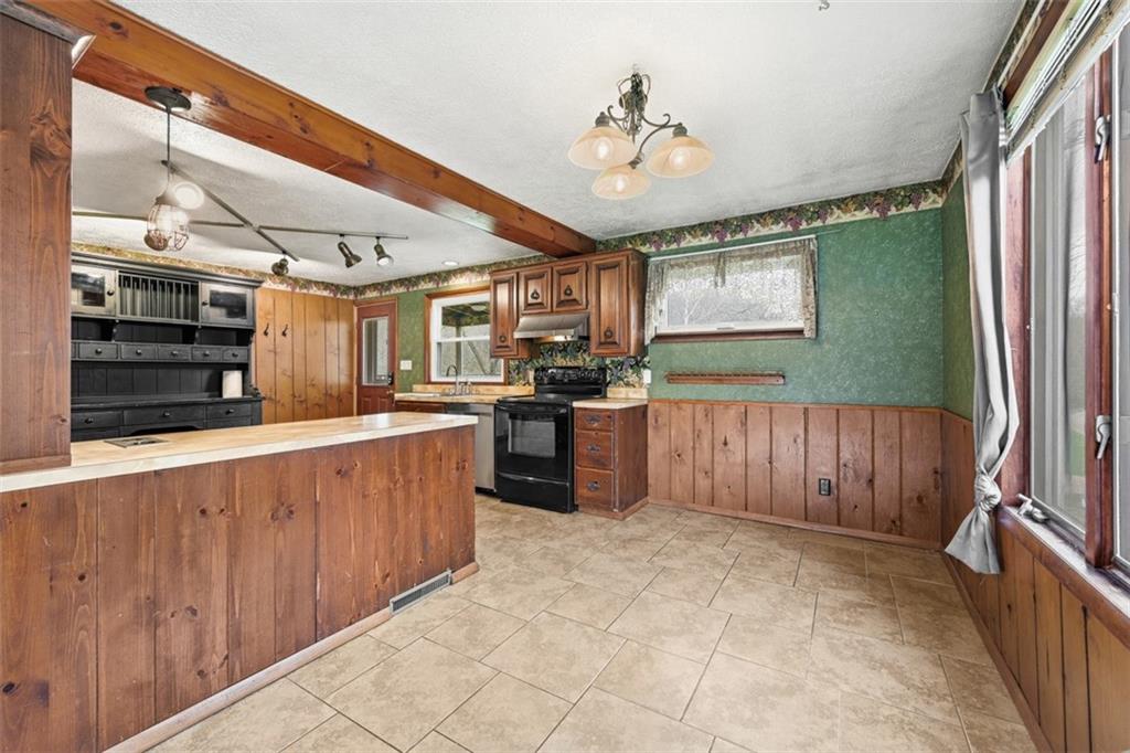 192 Yellow Creek Road Harmony, PA 16037 - Photo 7 of 41 a kitchen with stainless steel appliances kitchen island granite countertop a refrigerator and a stove top oven