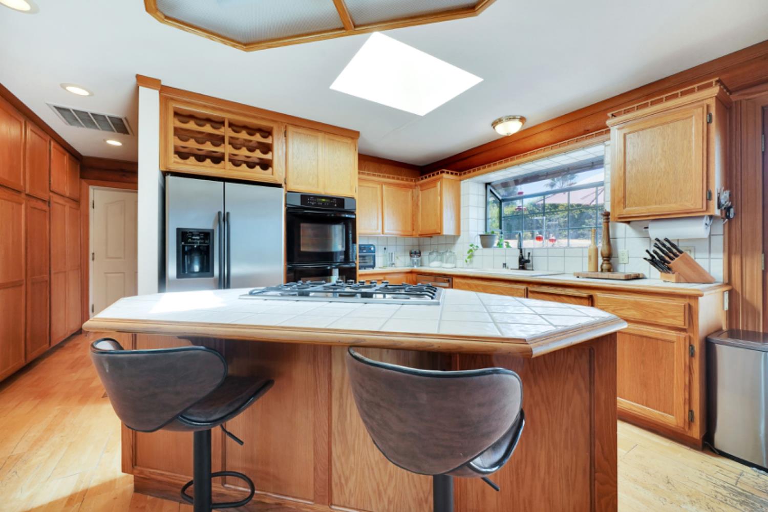 391 Spyglass Road Valley Springs, CA 95252 - Photo 14 of 30 a kitchen with stainless steel appliances granite countertop a sink and a refrigerator