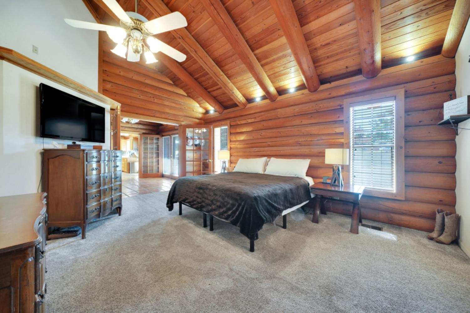 391 Spyglass Road Valley Springs, CA 95252 - Photo 19 of 30 a spacious bedroom with a bed and a flat screen tv