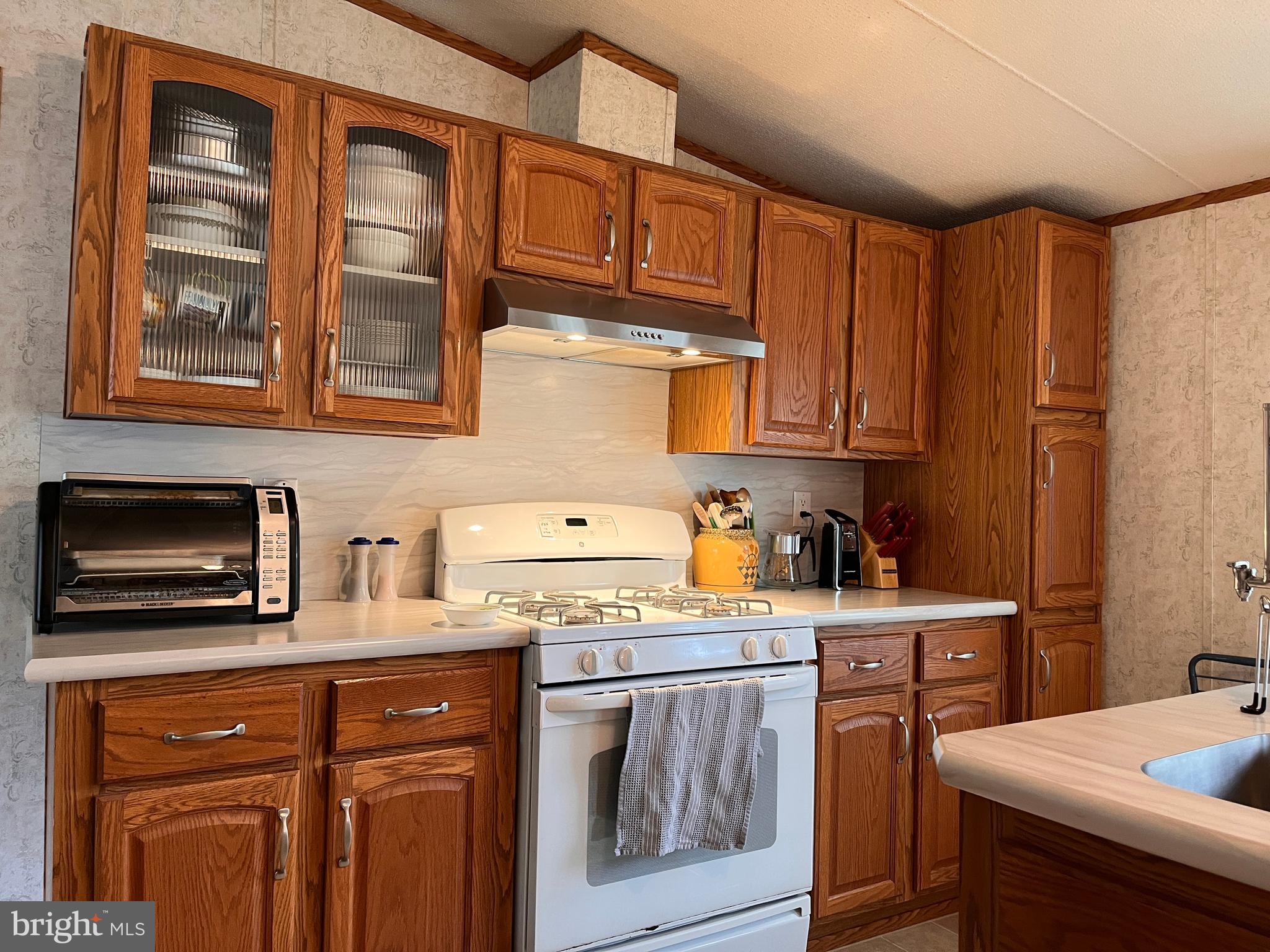 111 Nancy Boulevard Middletown, PA 17057 - Photo 11 of 28 a kitchen with stainless steel appliances granite countertop a stove a sink dishwasher and cabinets with wooden floor