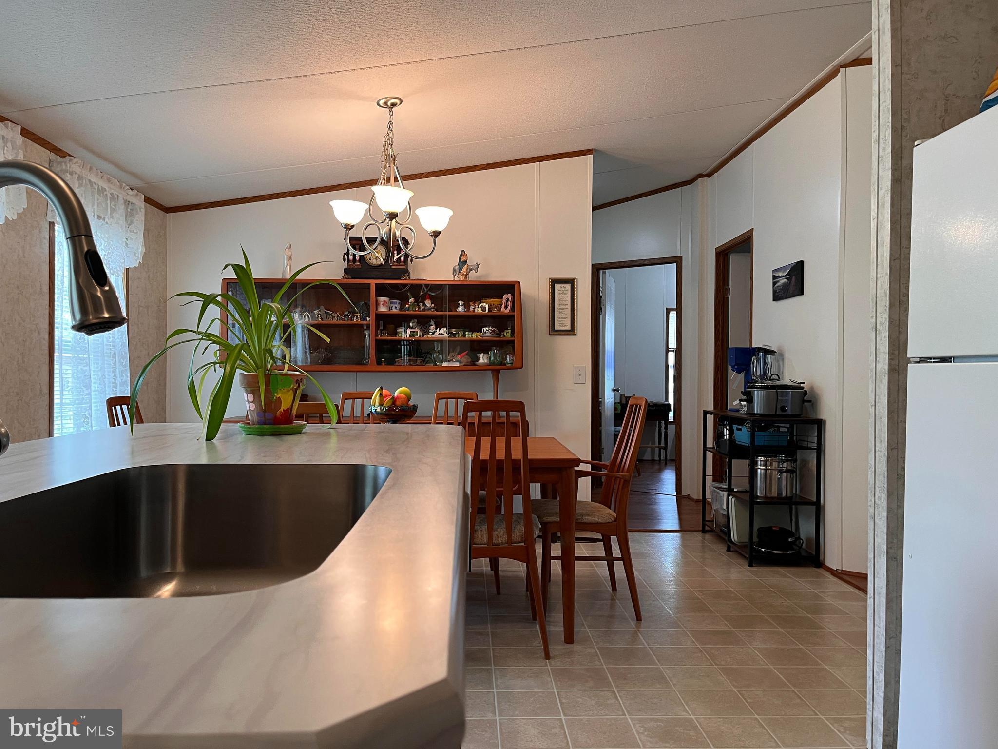 111 Nancy Boulevard Middletown, PA 17057 - Photo 13 of 28 a kitchen with stainless steel appliances granite countertop a sink dishwasher and a dining table with wooden floor