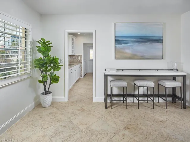 a view of a livingroom with furniture and a potted plant
