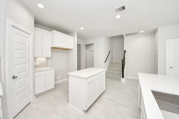 a view of an empty room with a window and a fireplace