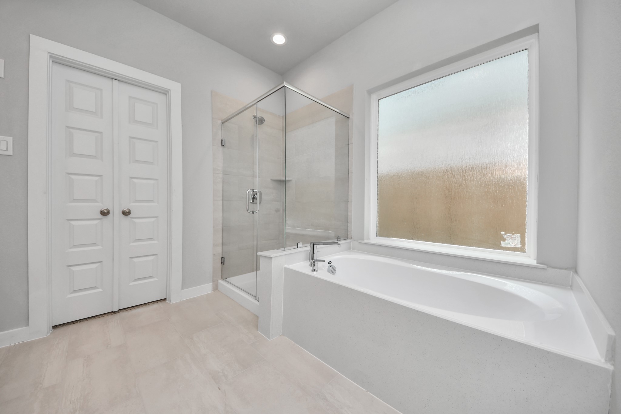 2946 Burris Park Drive Spring, TX 77373 - Photo 27 of 45 Indulge in a spa-like retreat within the confines of this primary bathroom. Delight in a spacious walk-in shower enveloped in stylish tile surround, unwind in a separate garden tub adorned with custom detailing.
