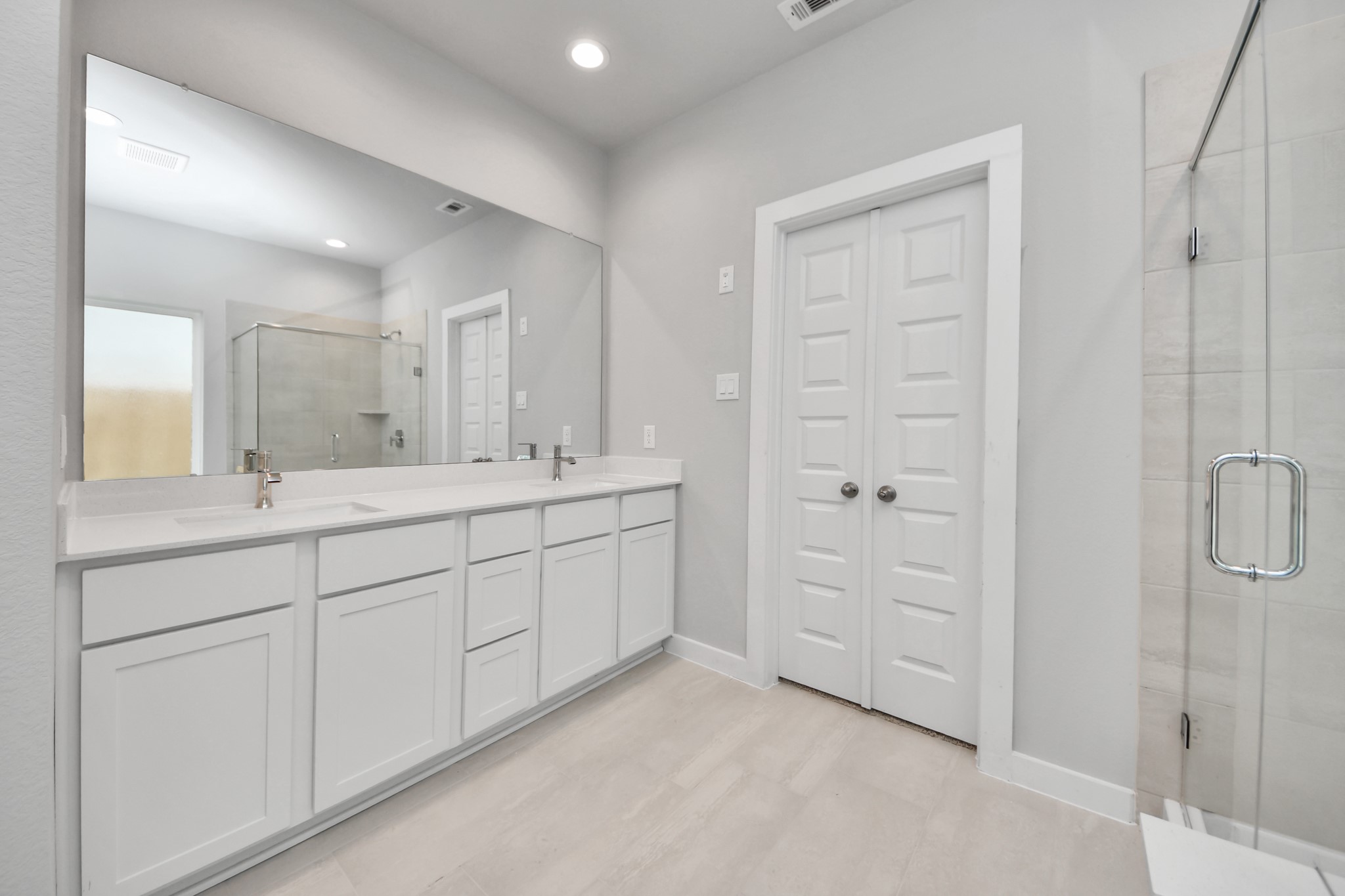 2946 Burris Park Drive Spring, TX 77373 - Photo 28 of 45 a spacious bathroom with a double vanity sink a mirror a shower and