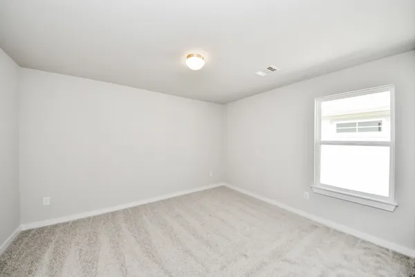 an empty room with closet area