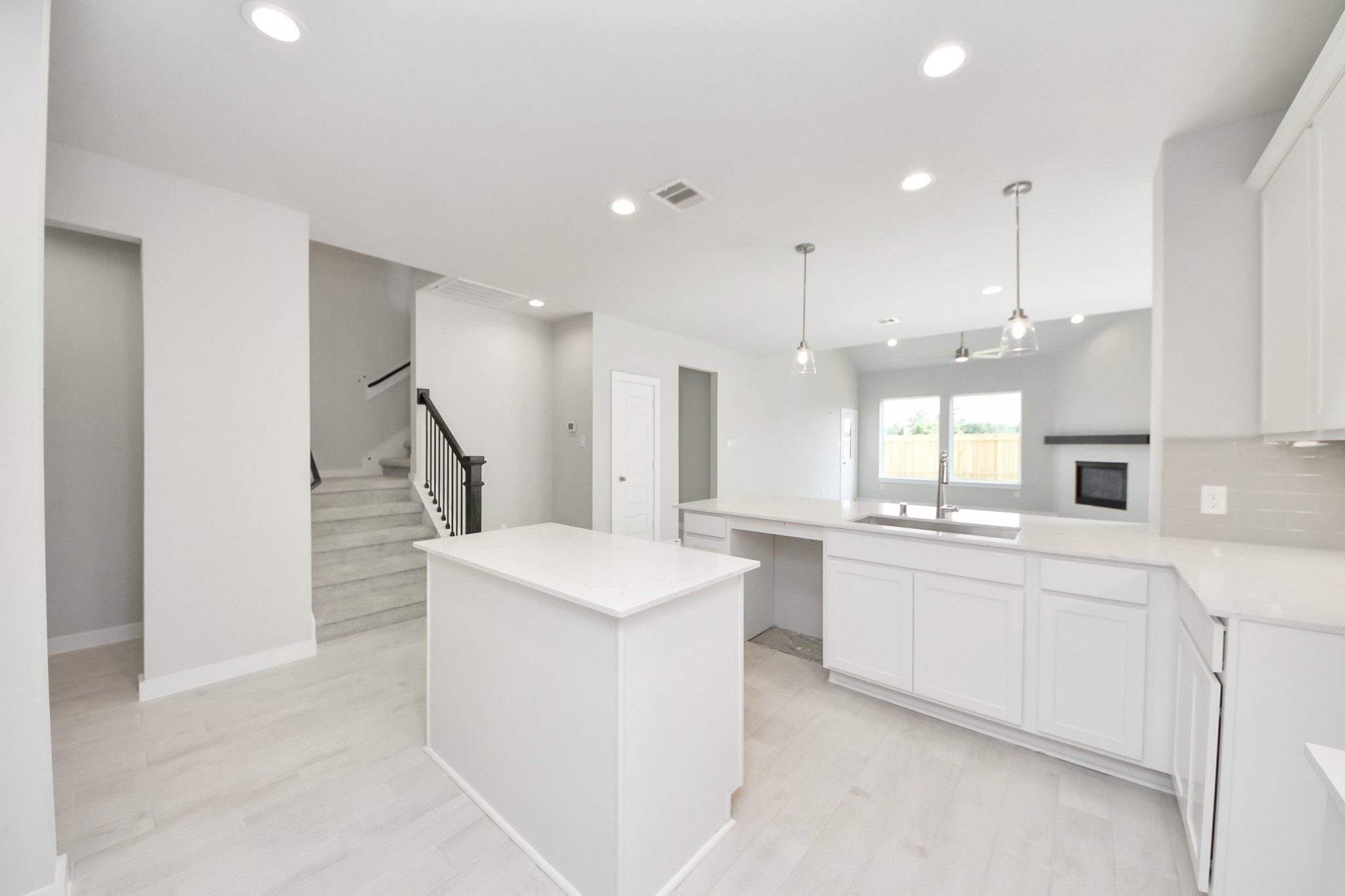 2946 Burris Park Drive Spring, TX 77373 - Photo 10 of 37 a large white kitchen with a sink and dishwasher a stove a refrigerator with wooden floor