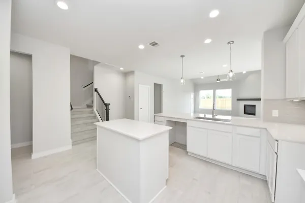 a kitchen with white cabinets and white appliances