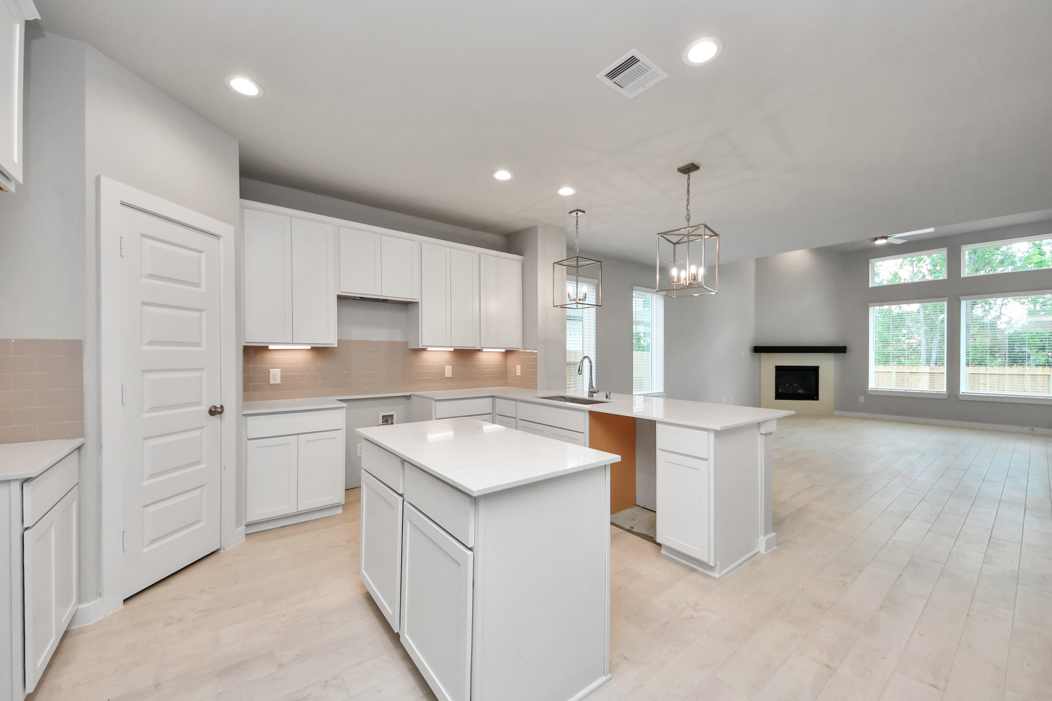 2946 Burris Park Drive Spring, TX 77373 - Photo 10 of 45 a kitchen with kitchen island a sink stainless steel appliances and white cabinets