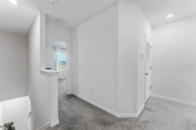 a view of a hallway with wooden shelves
