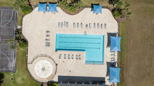 an aerial view of a house with wooden fence and floor