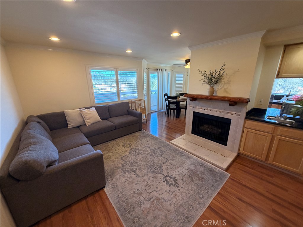 19804 Sandpiper Place, Unit 9 Newhall, CA 91321 - Photo 1 of 27 a living room with furniture a flat screen tv and a fireplace