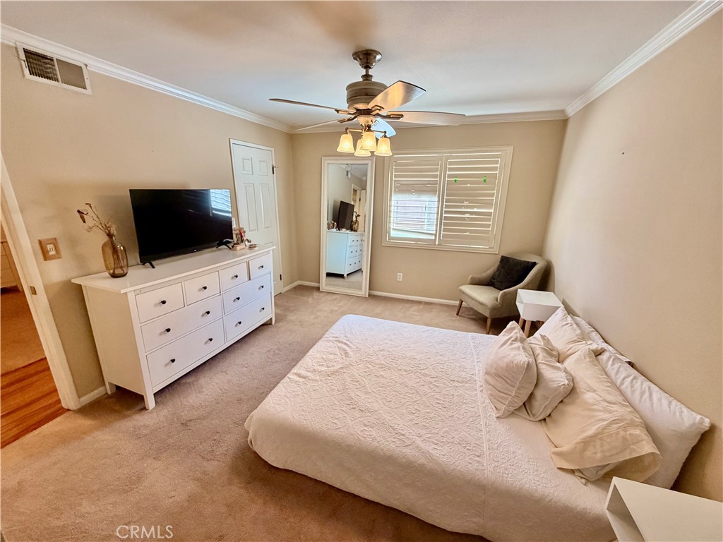 19804 Sandpiper Place, Unit 9 Newhall, CA 91321 - Photo 11 of 27 a bedroom with a bed and a flat screen tv