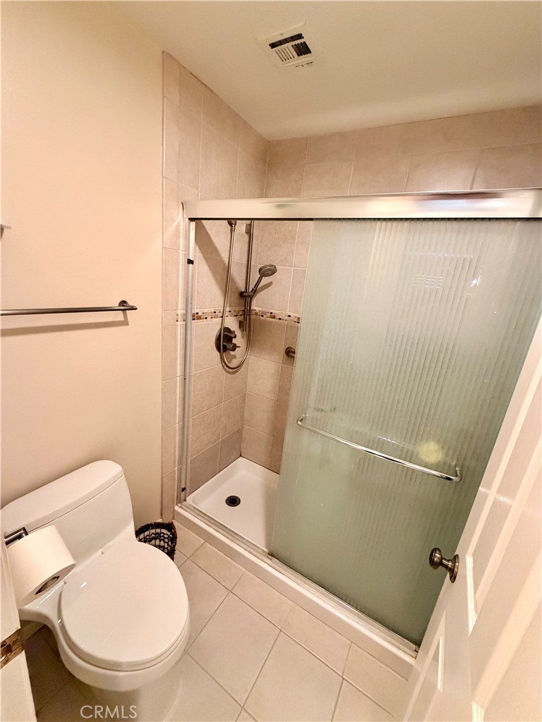 19804 Sandpiper Place, Unit 9 Newhall, CA 91321 - Photo 13 of 27 a bathroom with a toilet and a shower
