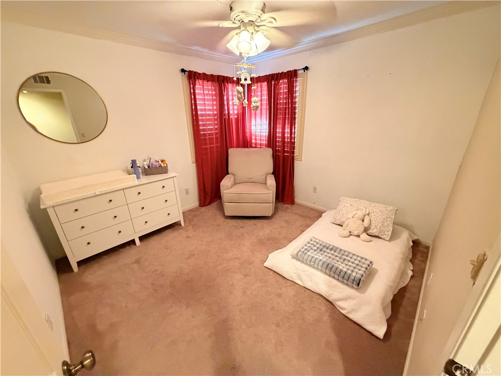 19804 Sandpiper Place, Unit 9 Newhall, CA 91321 - Photo 15 of 27 a bedroom with a bed and a chandelier