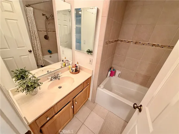 a bathroom with a sink vanity tub and shower