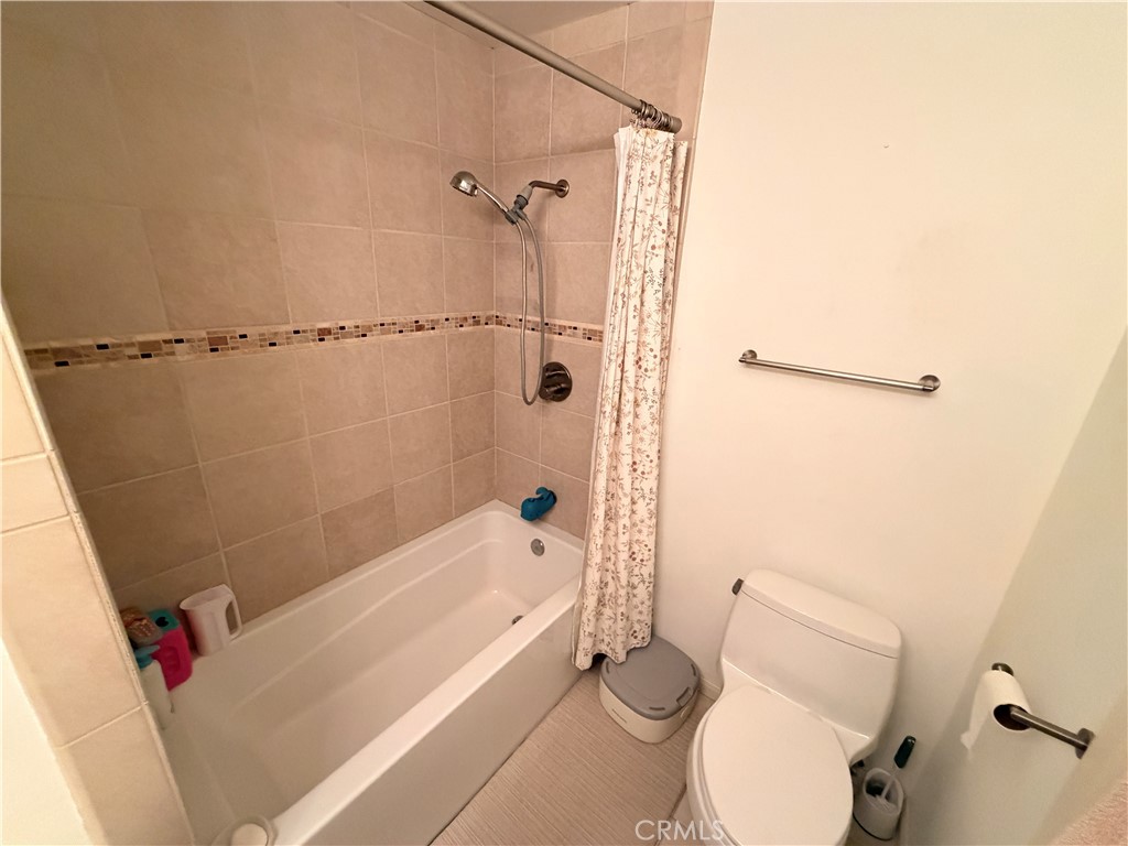 19804 Sandpiper Place, Unit 9 Newhall, CA 91321 - Photo 17 of 27 a white toilet sitting next to a bath tub