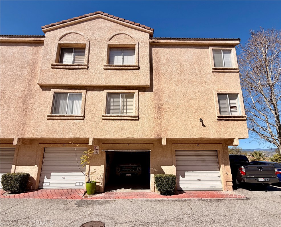 19804 Sandpiper Place, Unit 9 Newhall, CA 91321 - Photo 24 of 27 a front view of a house with a yard