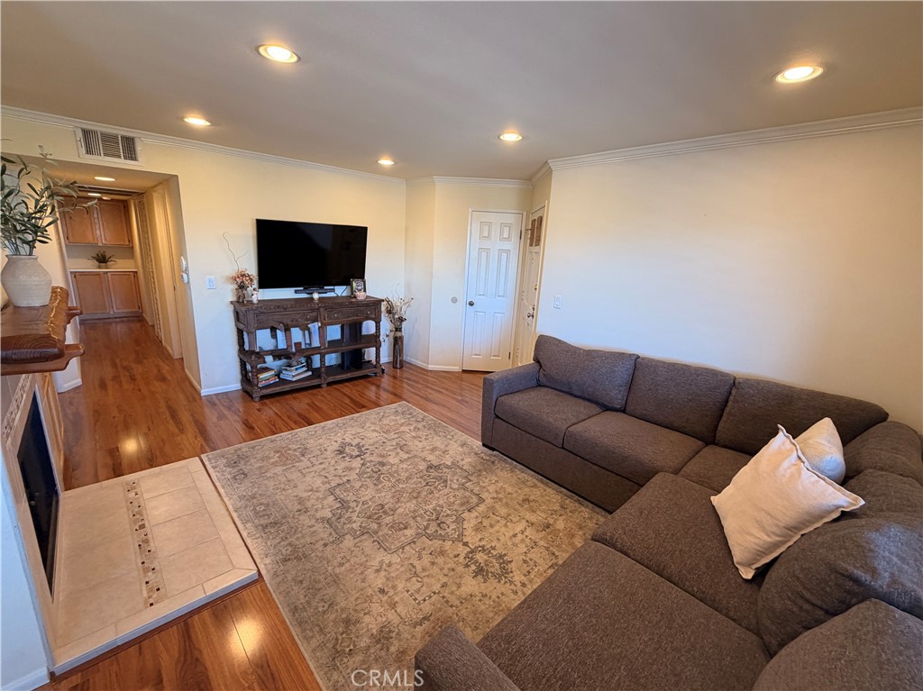 19804 Sandpiper Place, Unit 9 Newhall, CA 91321 - Photo 3 of 27 a living room with furniture and a flat screen tv