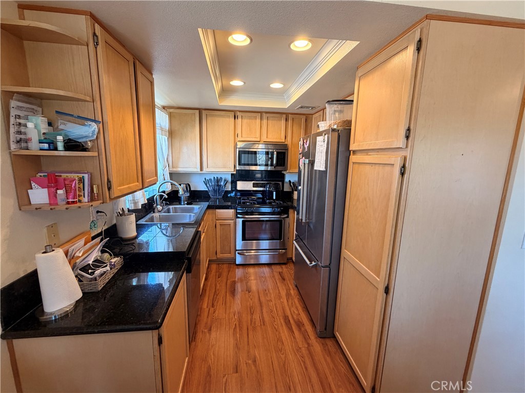 19804 Sandpiper Place, Unit 9 Newhall, CA 91321 - Photo 7 of 27 a kitchen with granite countertop a refrigerator a stove top oven a sink and dishwasher