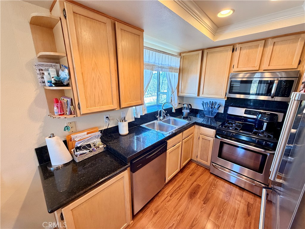 19804 Sandpiper Place, Unit 9 Newhall, CA 91321 - Photo 8 of 27 a kitchen that has a sink and a stove