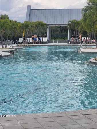 a view of a swimming pool and sitting area