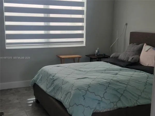 a bedroom with a bed and window