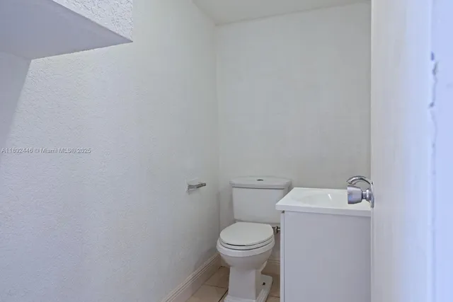 a white toilet sitting next to a white sink