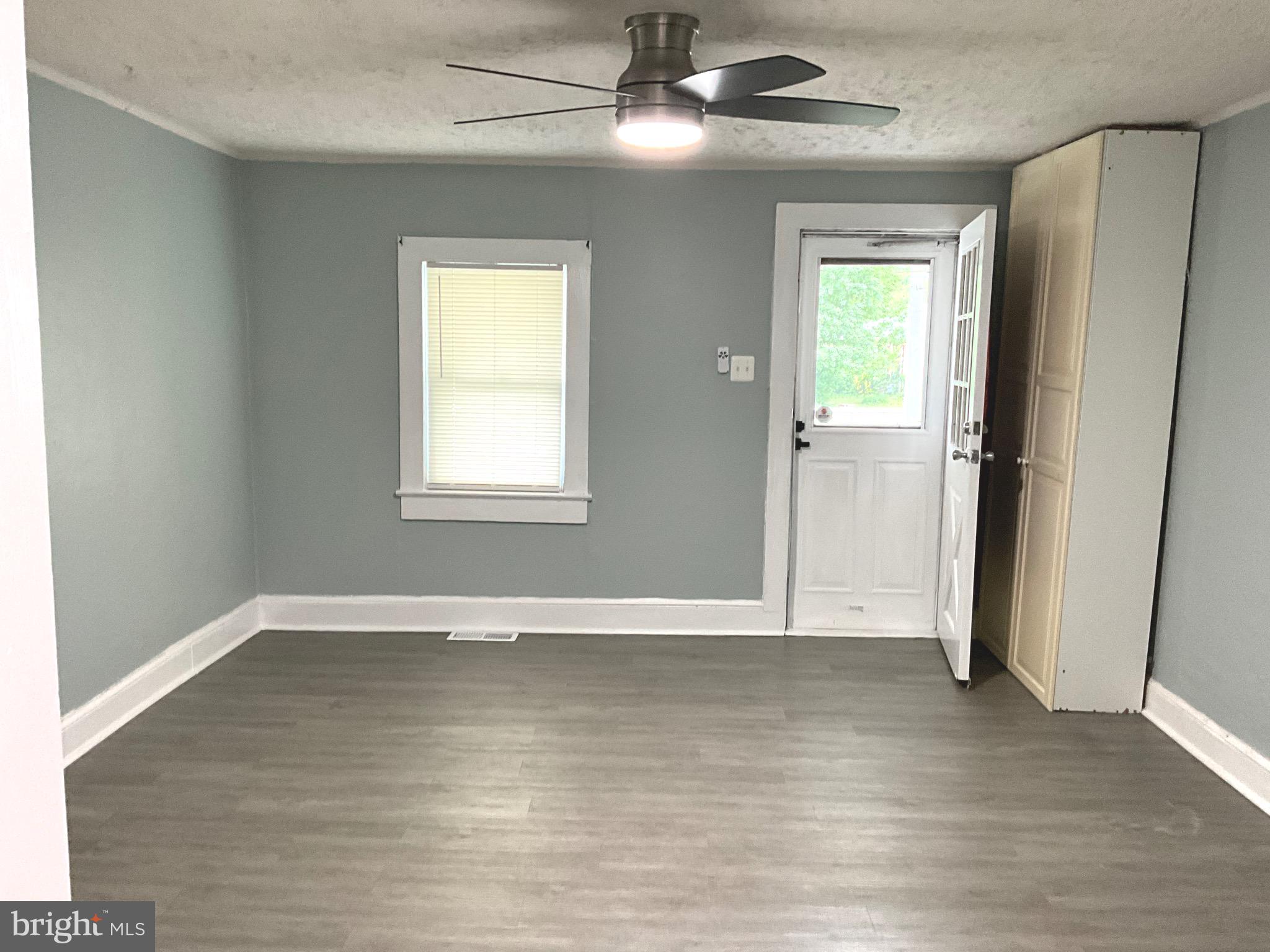 86 Kelley Road Fredericksburg, VA 22405 - Photo 4 of 36 an empty room with wooden floor closet and windows