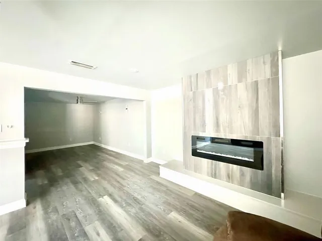 a view of a hardwood floor and a ceiling fan