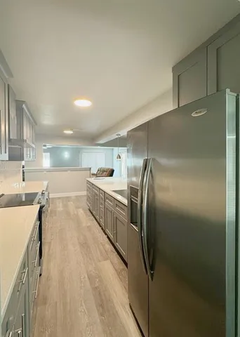 a kitchen with stainless steel appliances a refrigerator and a stove top oven