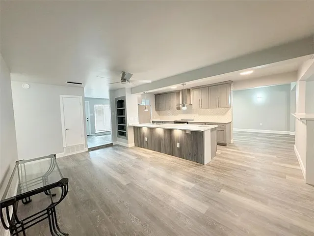 a large kitchen with kitchen island a sink stainless steel appliances and cabinets