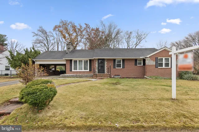 a view of a house with pool and a yard