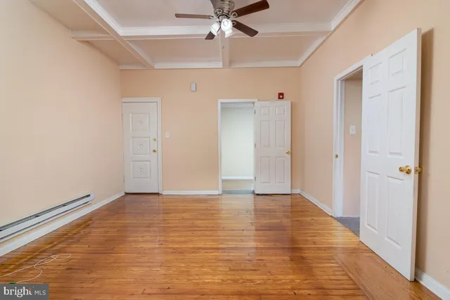 a view of an empty room with a ceiling fan