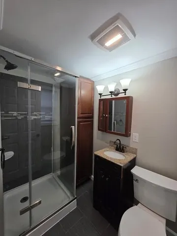 a bathroom with a sink toilet and shower