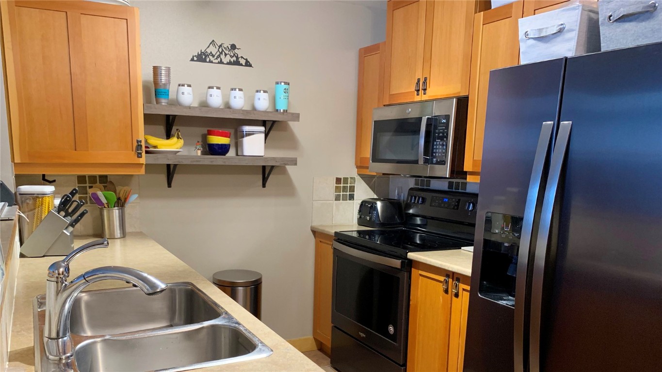910 Copper Road, Unit 122 Copper Mountain, CO 80443 - Photo 7 of 25 a kitchen with a refrigerator stove and sink