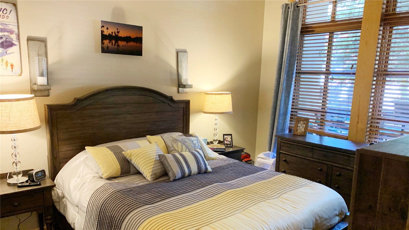 910 Copper Road, Unit 122 Copper Mountain, CO 80443 - Photo 8 of 25 a bedroom with a bed and a night stand