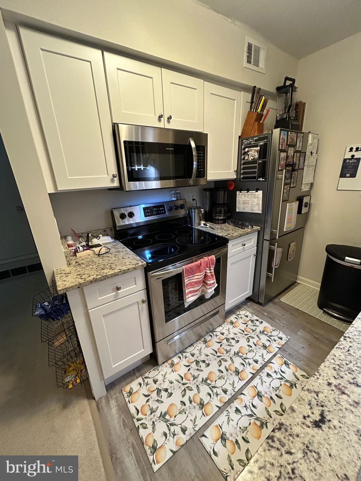 5821 E Royal Ridge Drive, Unit E Springfield, VA 22152 - Photo 10 of 20 a kitchen with stainless steel appliances a stove a sink and a refrigerator