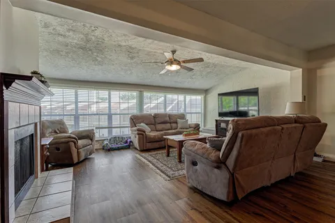 a living room with furniture ceiling fan and a rug