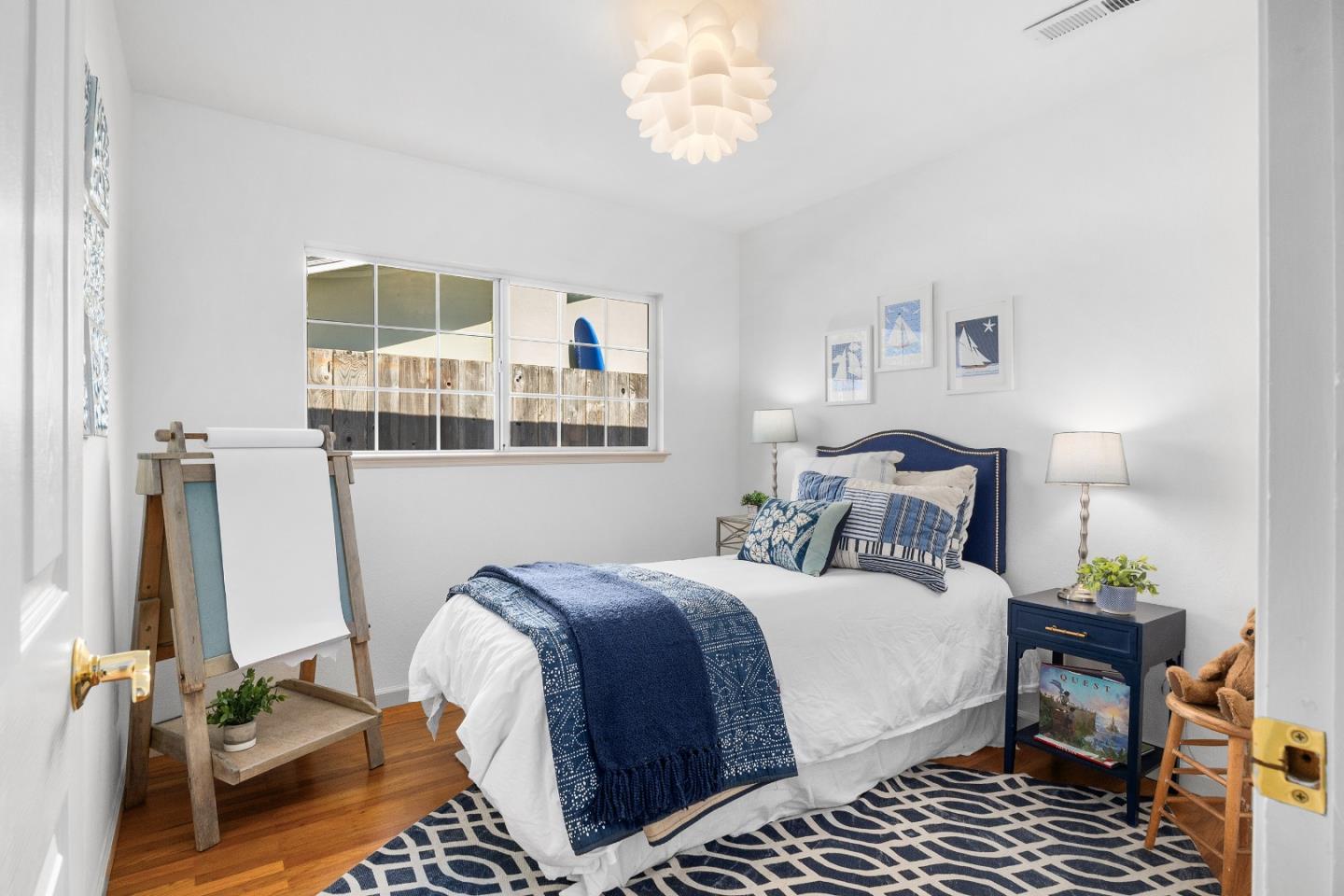 105 Wesley Street Capitola, CA 95010 - Photo 27 of 55 a bedroom with bed and wooden floor
