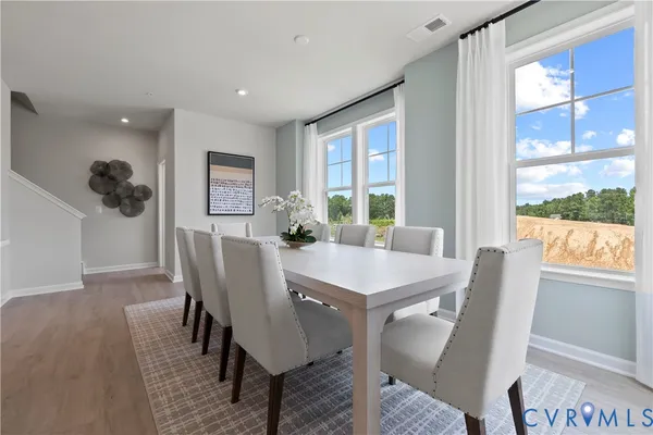 a view of a dining room with furniture window and wooden floor