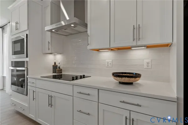 a kitchen with white cabinets and a sink