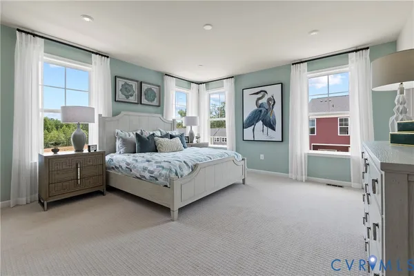 a bedroom with a large bed and a window