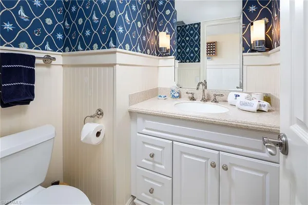 a bathroom with a sink toilet and mirror