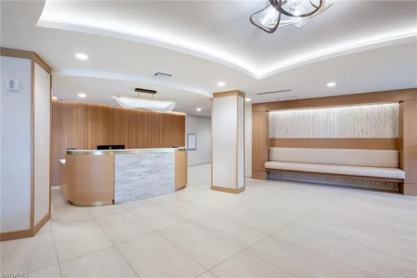 a view of kitchen with stainless steel appliances granite countertop a refrigerator and a microwave