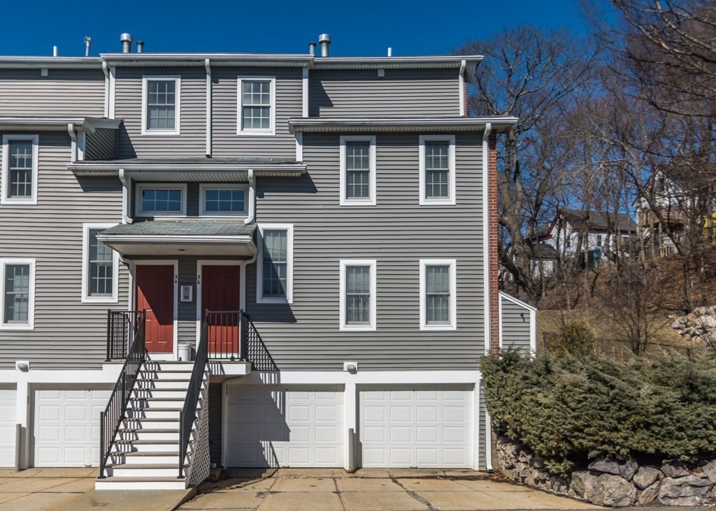 a front view of a house with plants