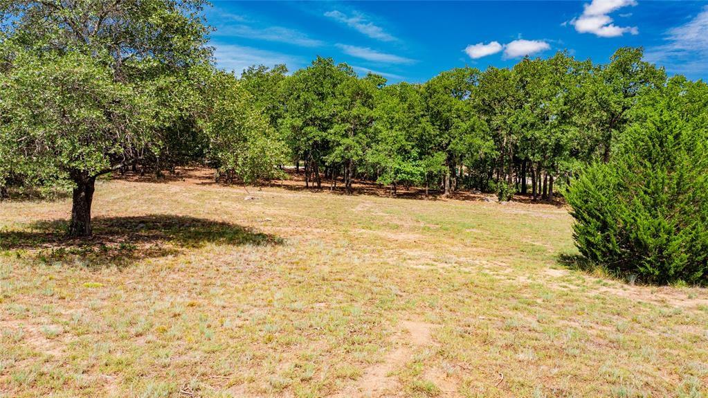 310 Rolling Bnd Road Alvord, TX 76225 - Photo 1 of 24 View of the 2-acre lot offering lots of trees and beautiful rolling terrain.