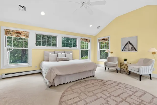 a spacious bedroom with a bed and a large window