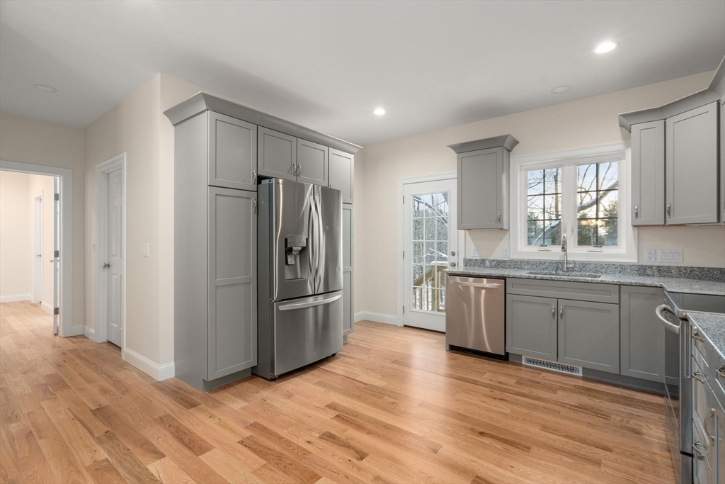 5 Miles Road Rutland, MA 01543 - Photo 12 of 35 a kitchen with granite countertop a refrigerator and wooden cabinets