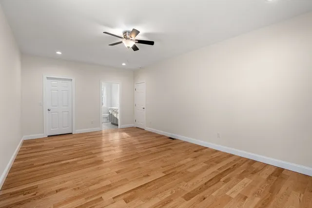a view of an empty room and wooden floor